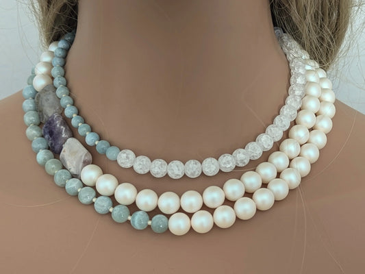 Handcrafted statement necklace featuring pearls and light blue dyed quartz.