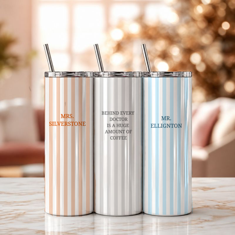 Three insulated tumblers with striped designs and personalized names on a blurred background.