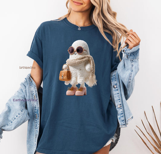 Crocheted Boojee ghost figure is on the midnight blue Comfort Colors shirt. The model has long blonde hair, her jean jacket fell down drom her arms to show her ghost printed shirt. She looks beautiful, sport, eye catching, cute and so happy.