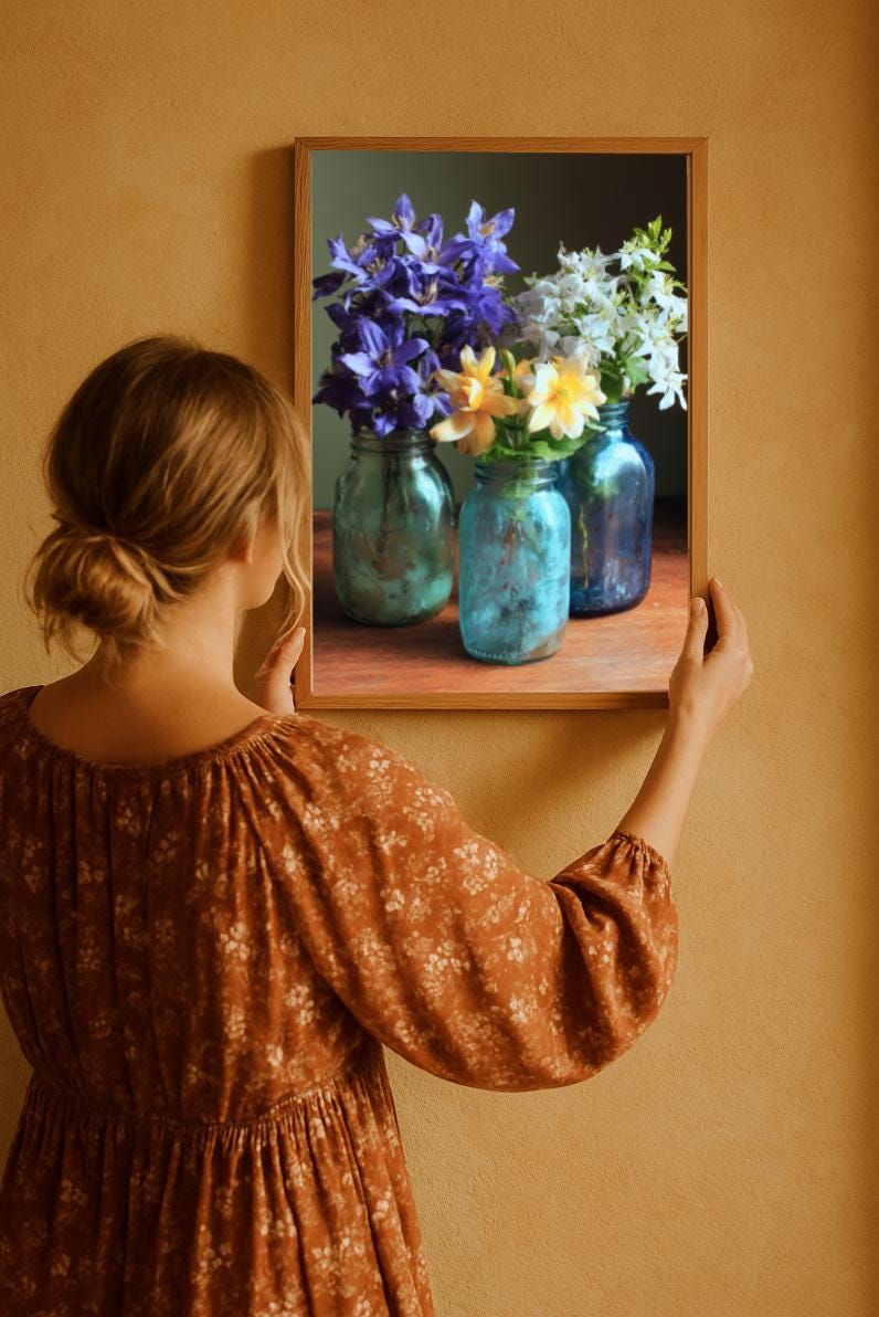 The woman is hanging cottage style floral print to her warm, terracota color wall. The flowers have vivid colors in vintage look jason jars.