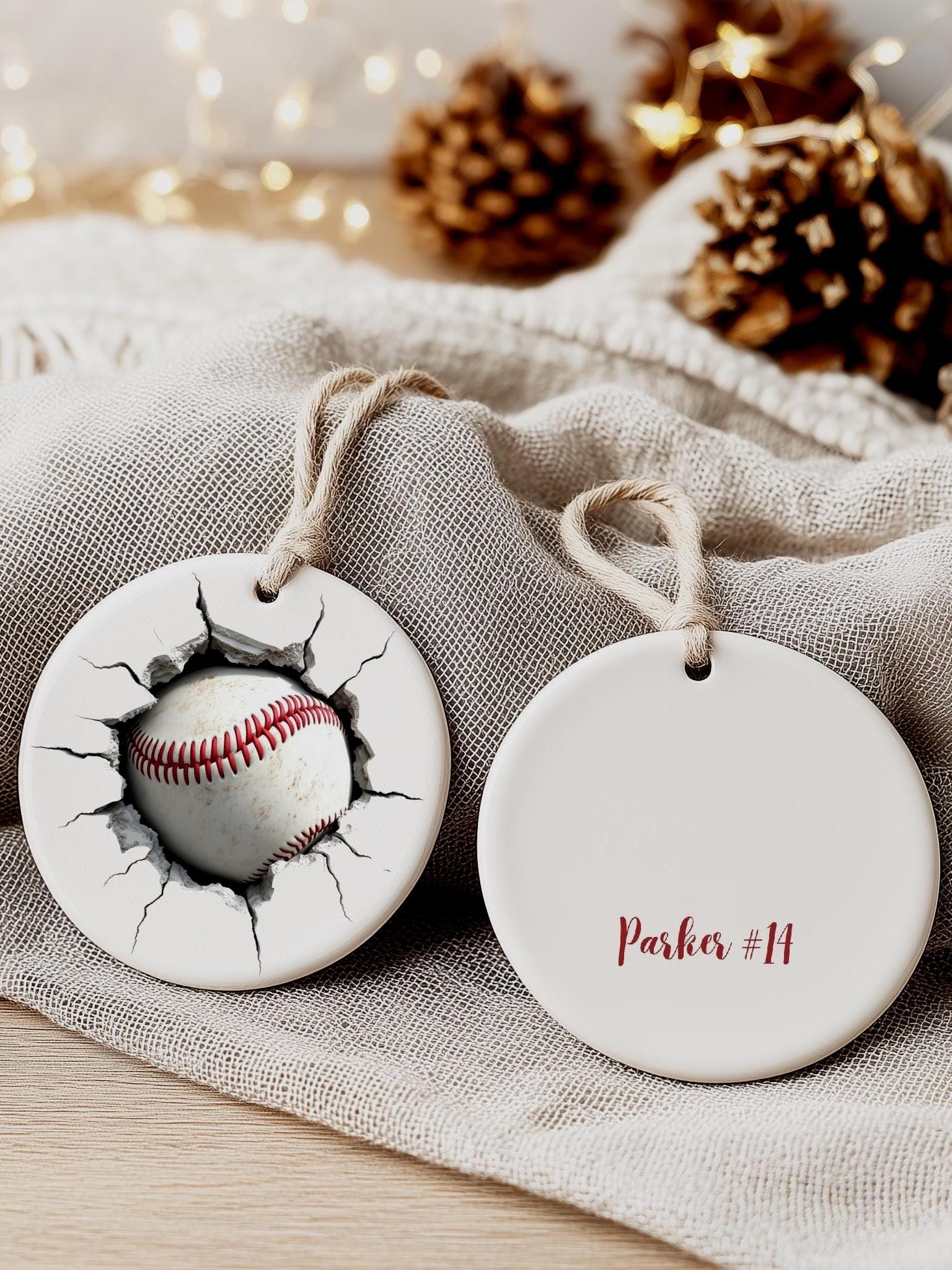 Personalized cracked baseball ornament with custom name on cloth background, sports-themed Christmas gift