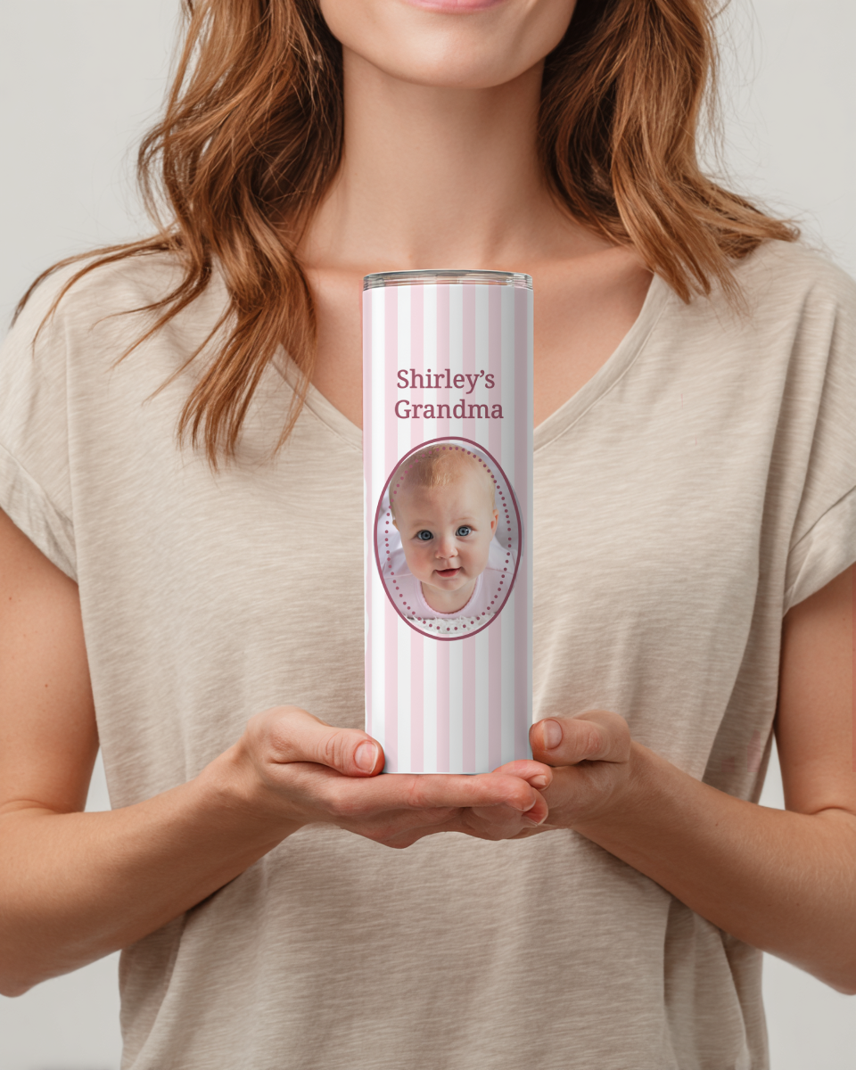 Person holding a personalized tumbler with a baby's face and 'Shirley's Grandma' text.