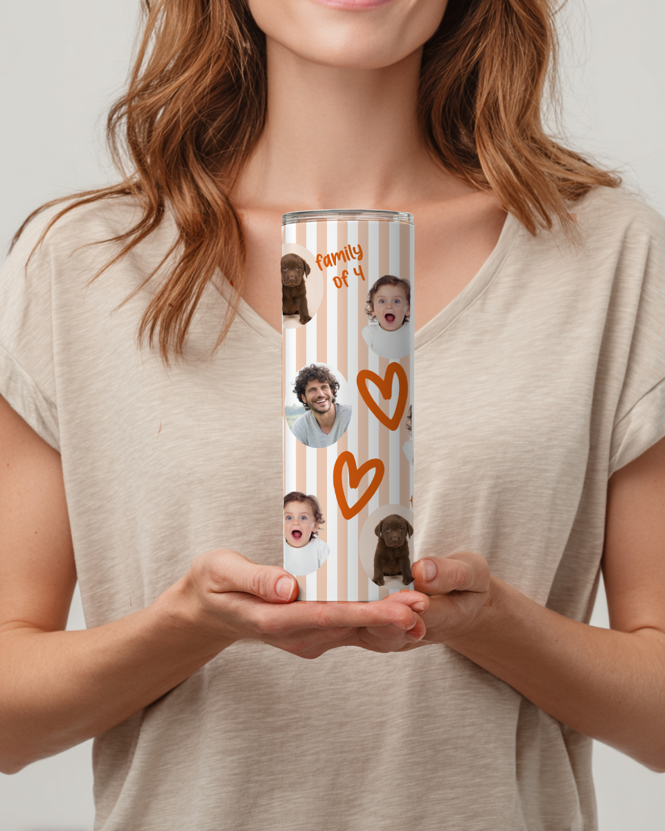 Person holding a cylindrical tumbler with family photos and heart designs.