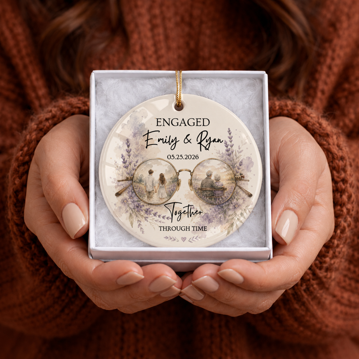 Engaged ornament on kraft gift box – round ceramic with glasses motif, young and old couple scenes, lavender floral wreath, custom names and date