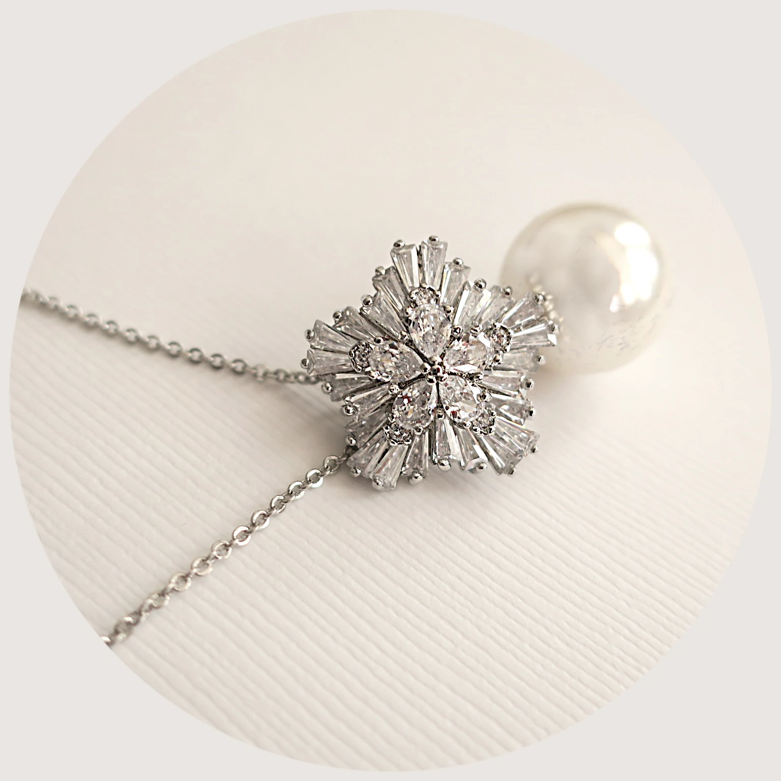 Elegant white ivory pearl drop and cubic zirconia snowflake necklace with a silver finish and adjustable chain, perfect for bridal and formal occasions